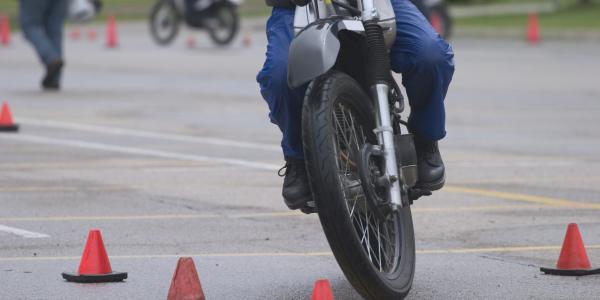 Close up of rider going through a pylon course at motorcycle school.