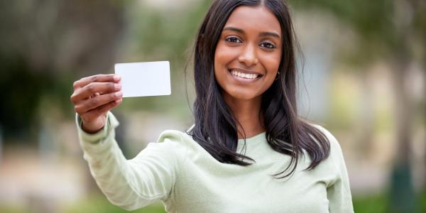 Young person holding an I.D. card.
